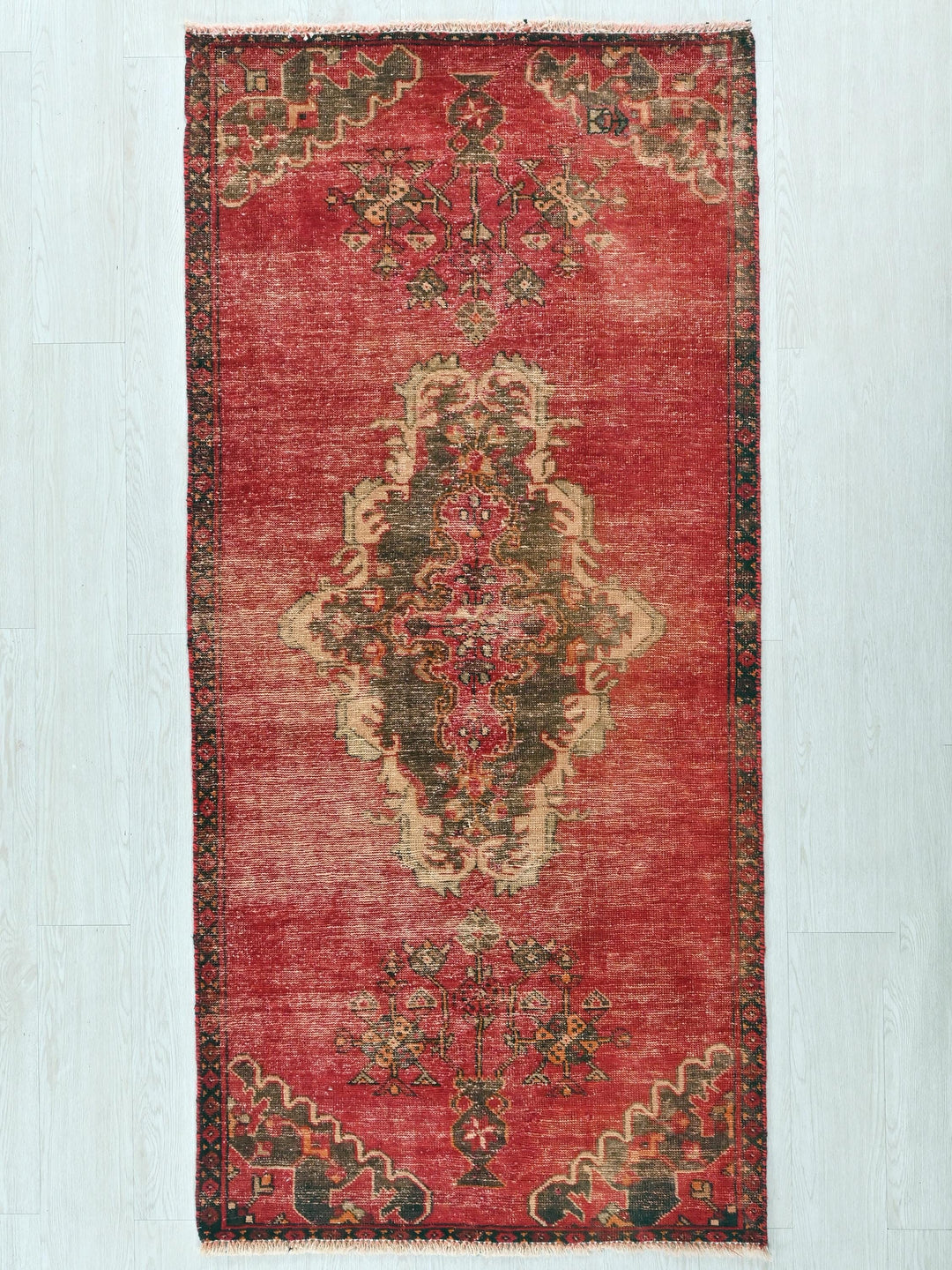 a red rug with a floral design on it