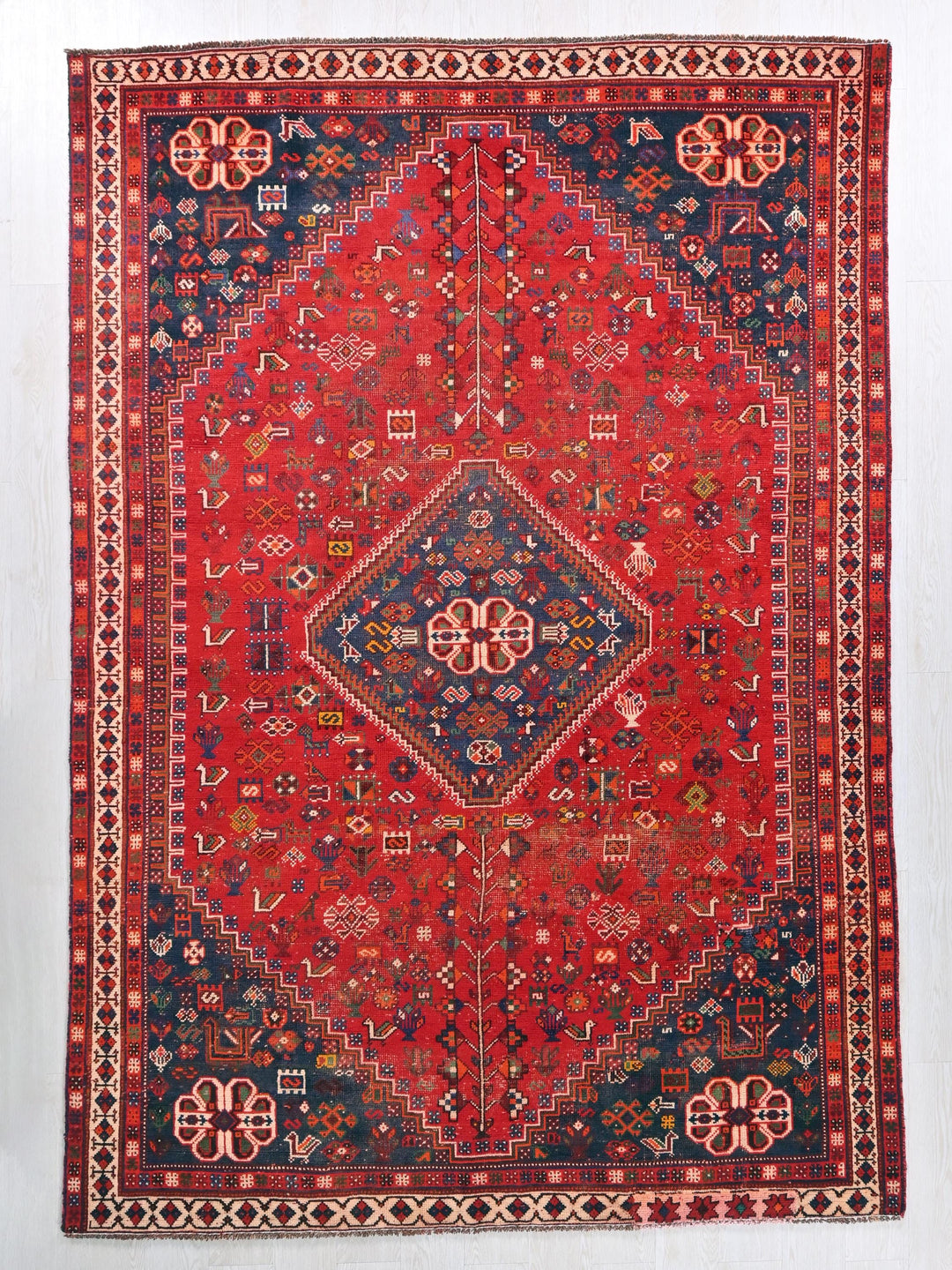 a red rug with a blue and red design