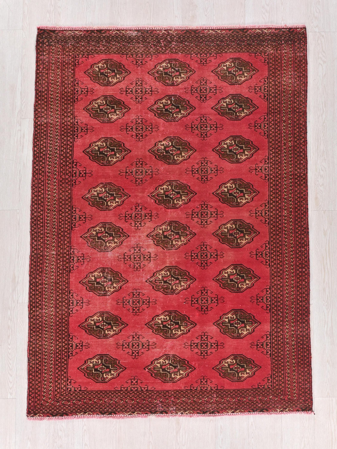 a red rug with a design on it