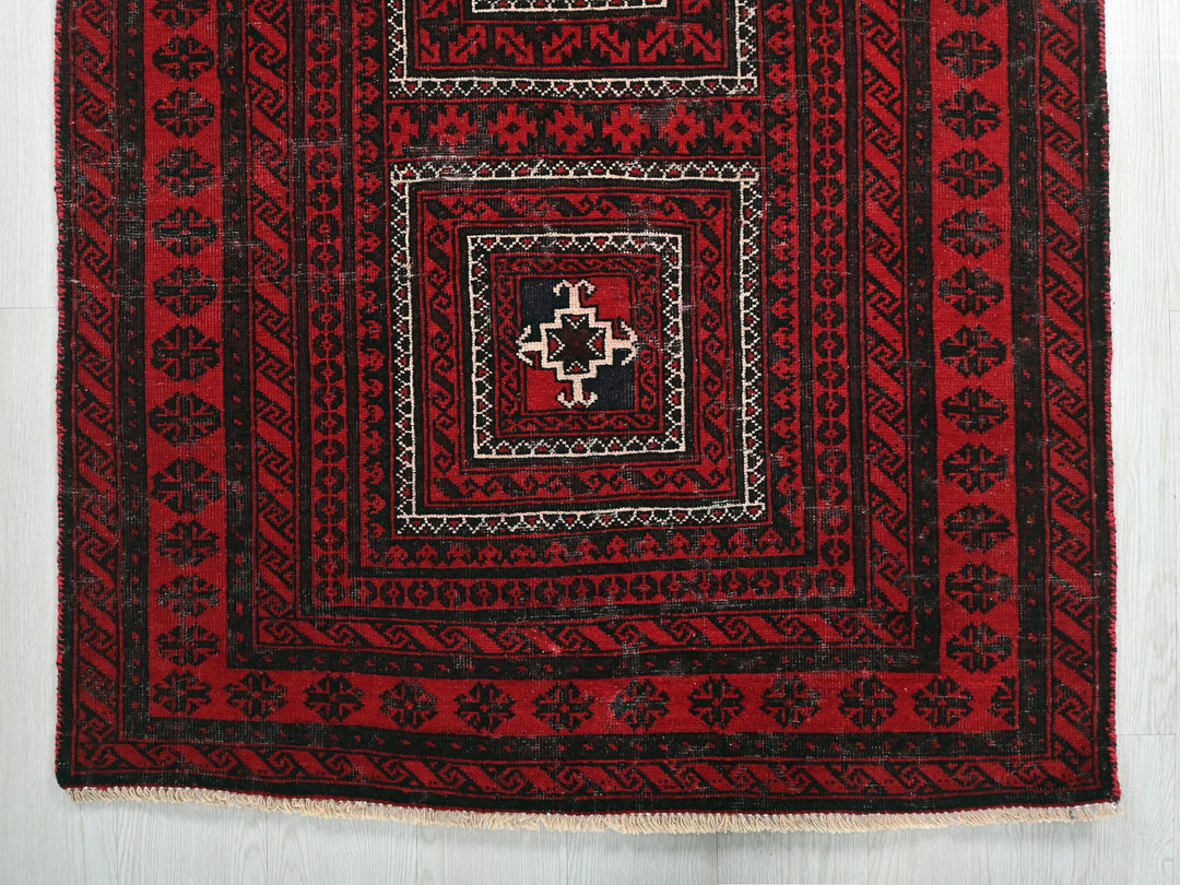 a red rug with black and white designs on it