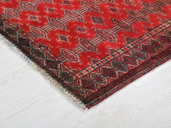 a red rug on a white wooden floor