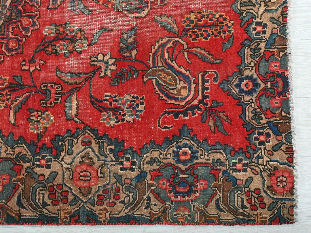 a red rug with a floral design on it