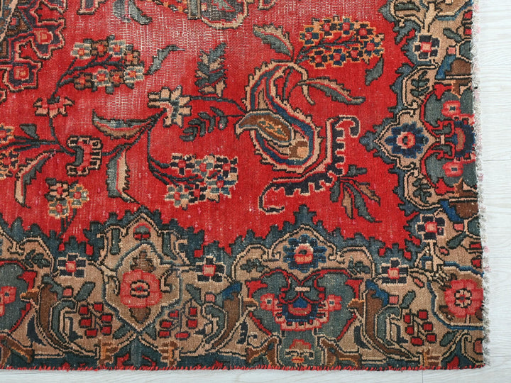 a red rug with a floral design on it