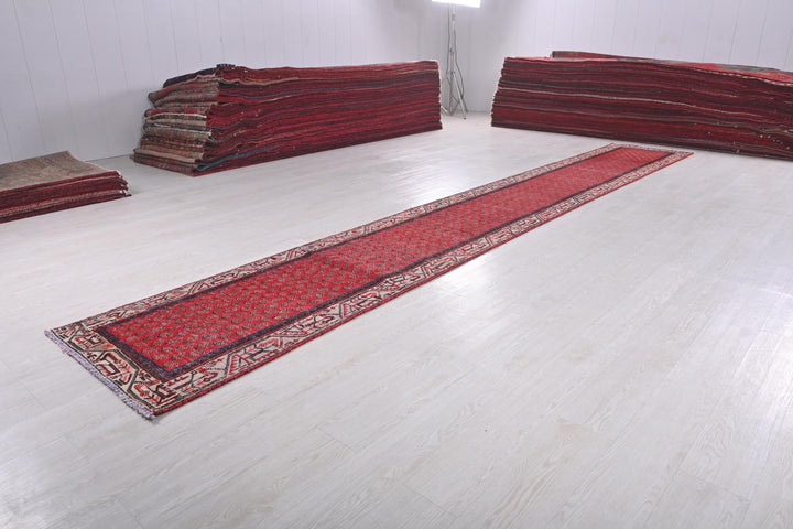 a pile of red rugs sitting on top of a white floor