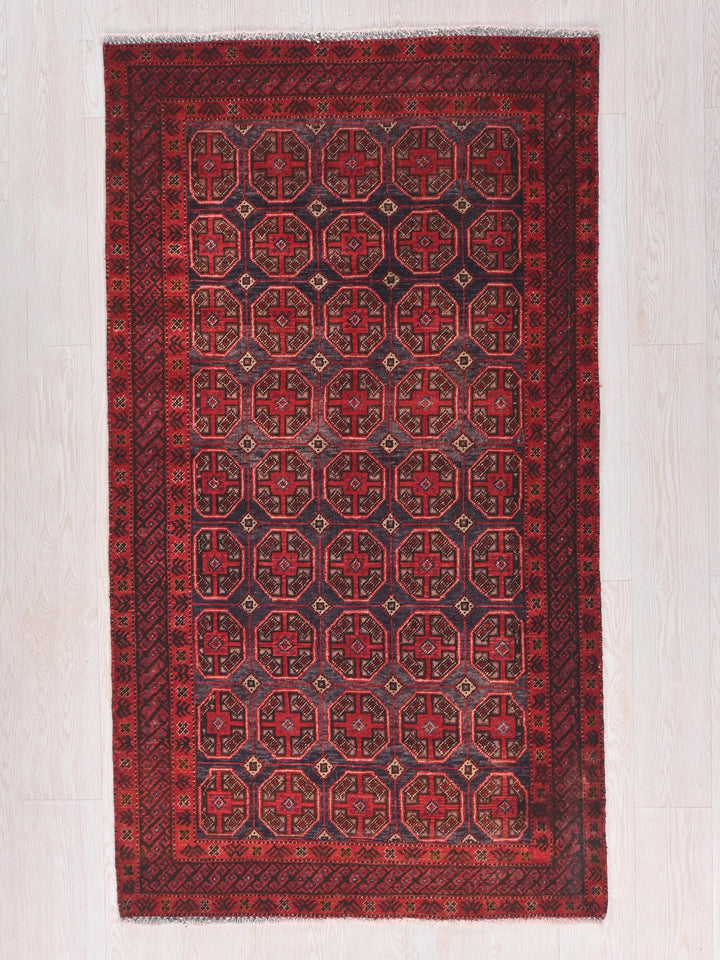 a red and black rug on a white floor