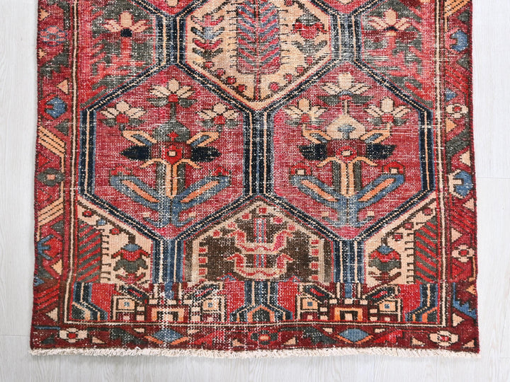a red rug with an intricate design on it