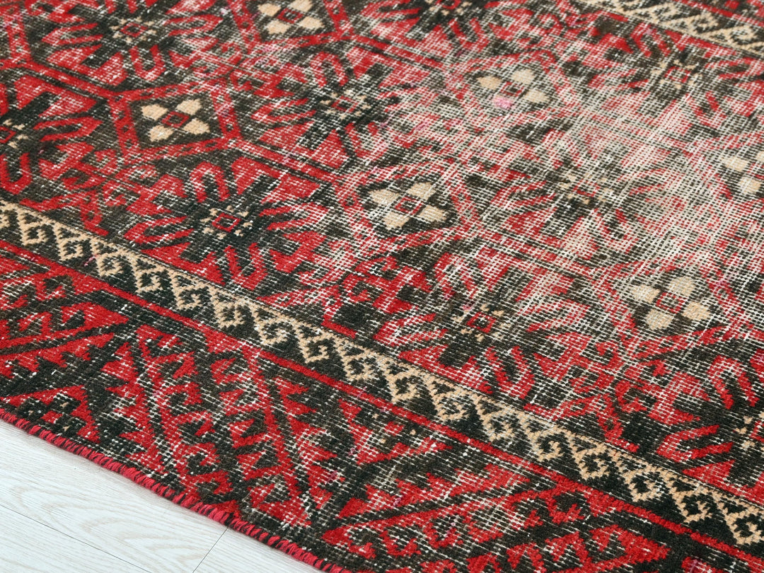 a close up of a red and black oriental rug