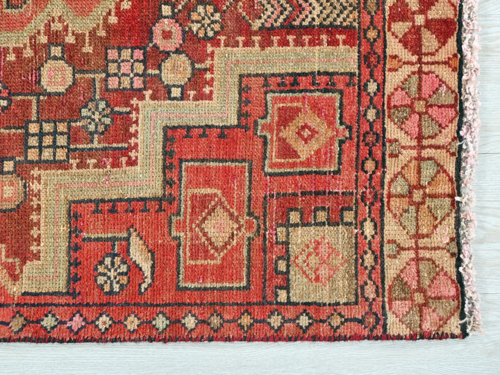 a red rug with a pattern on it