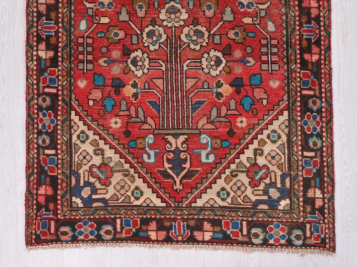a red rug with a floral design on it