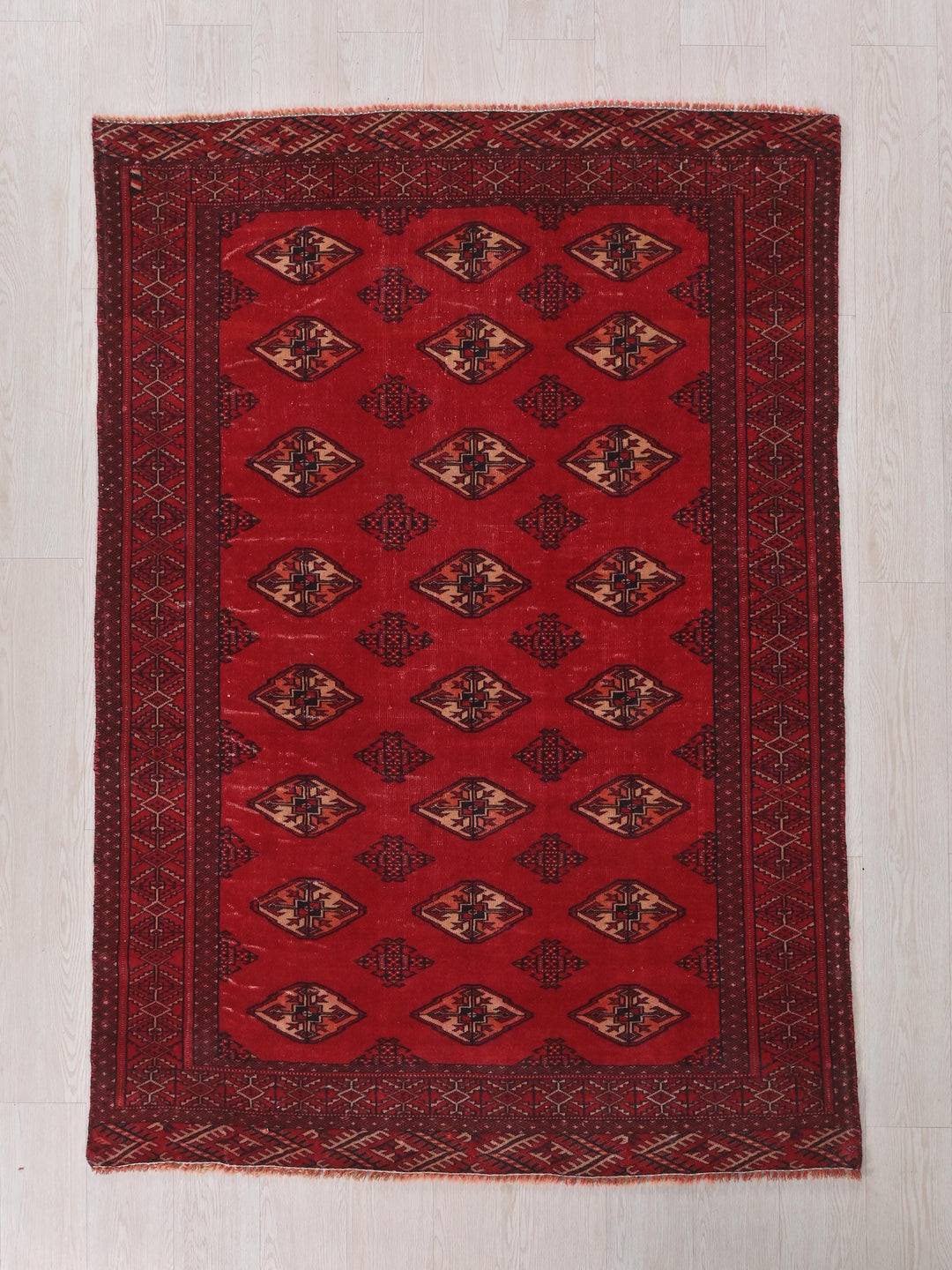 a red rug on a white floor
