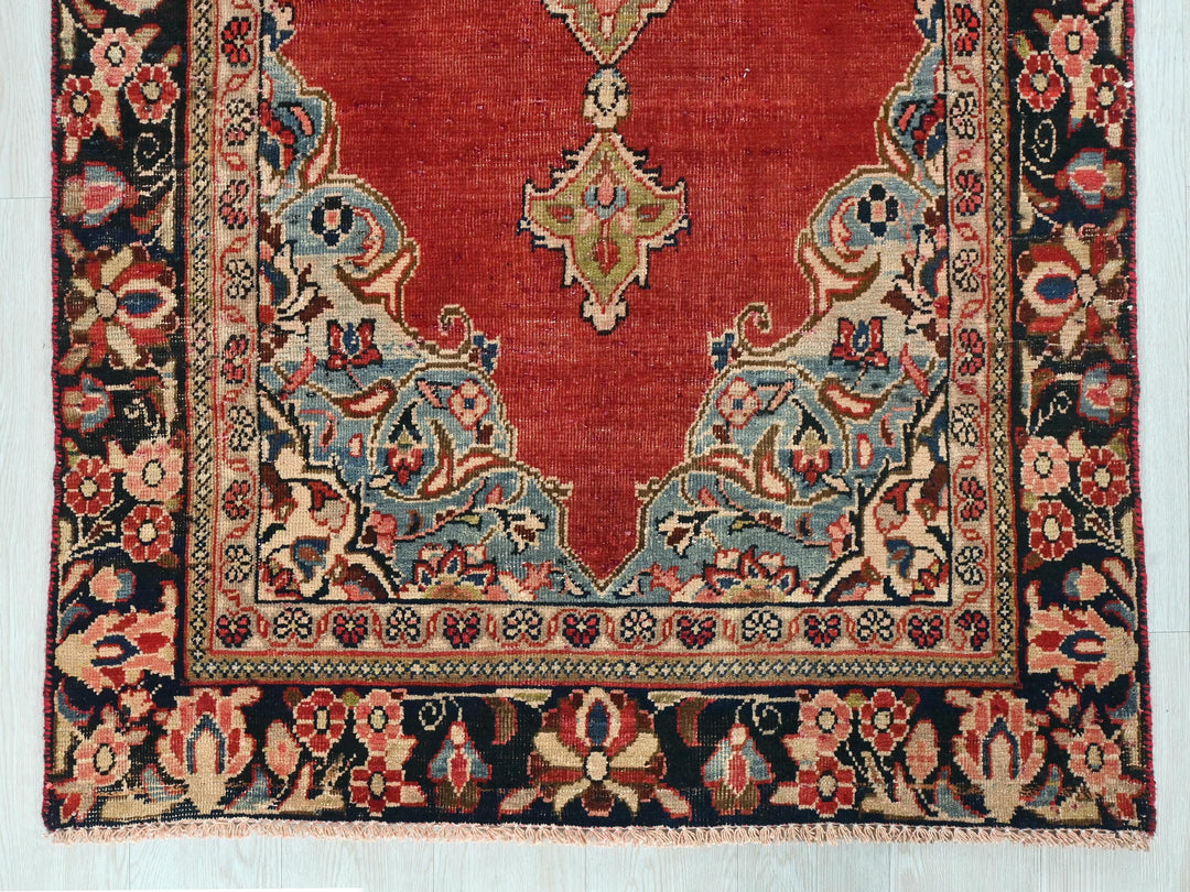 a red rug with an intricate design on it