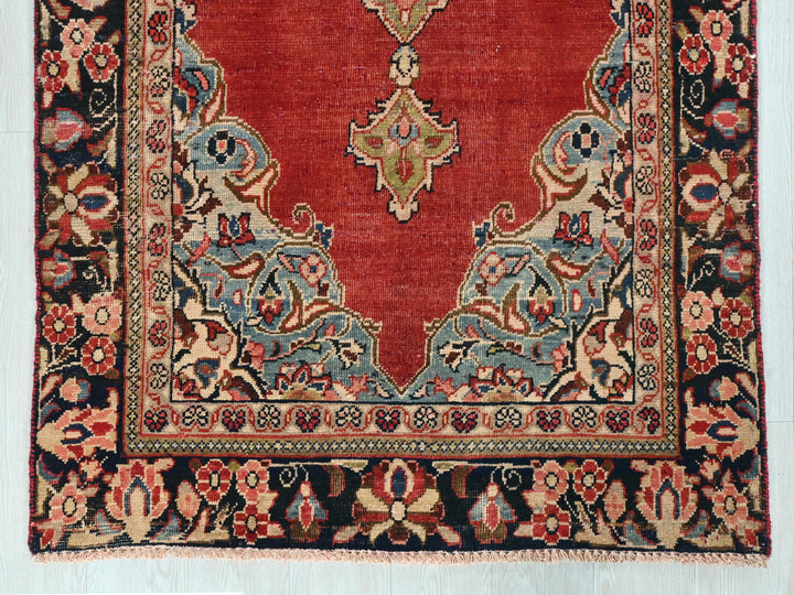 a red rug with an intricate design on it