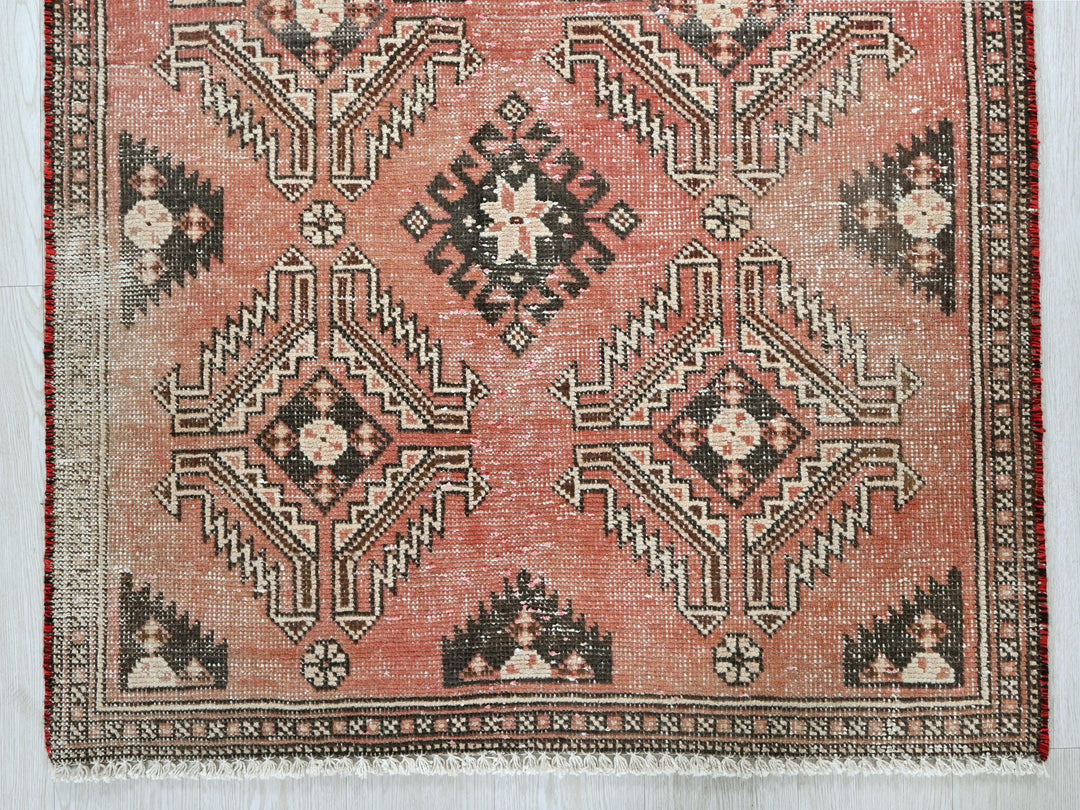 a red rug with a black and white design on it