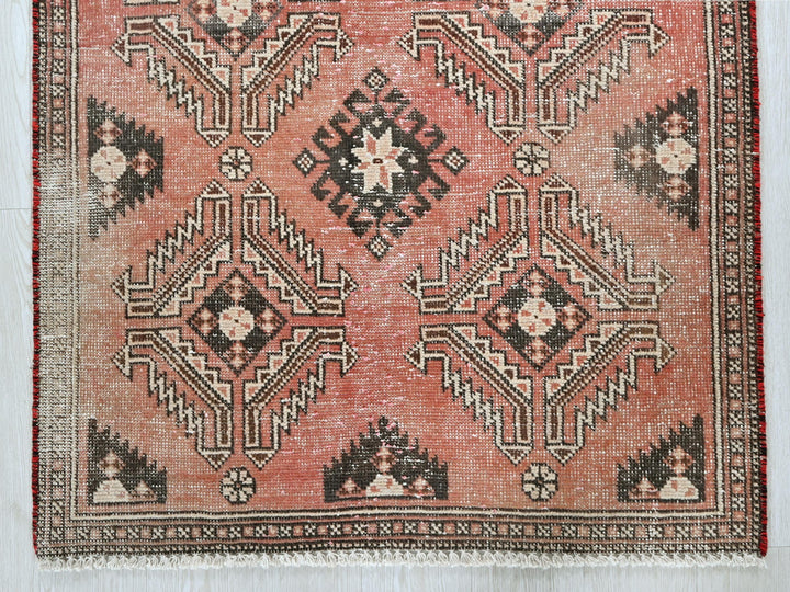 a red rug with a black and white design on it