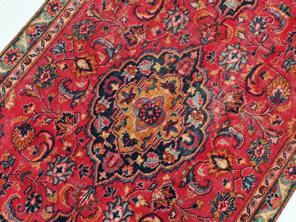 a red rug with an intricate design on it