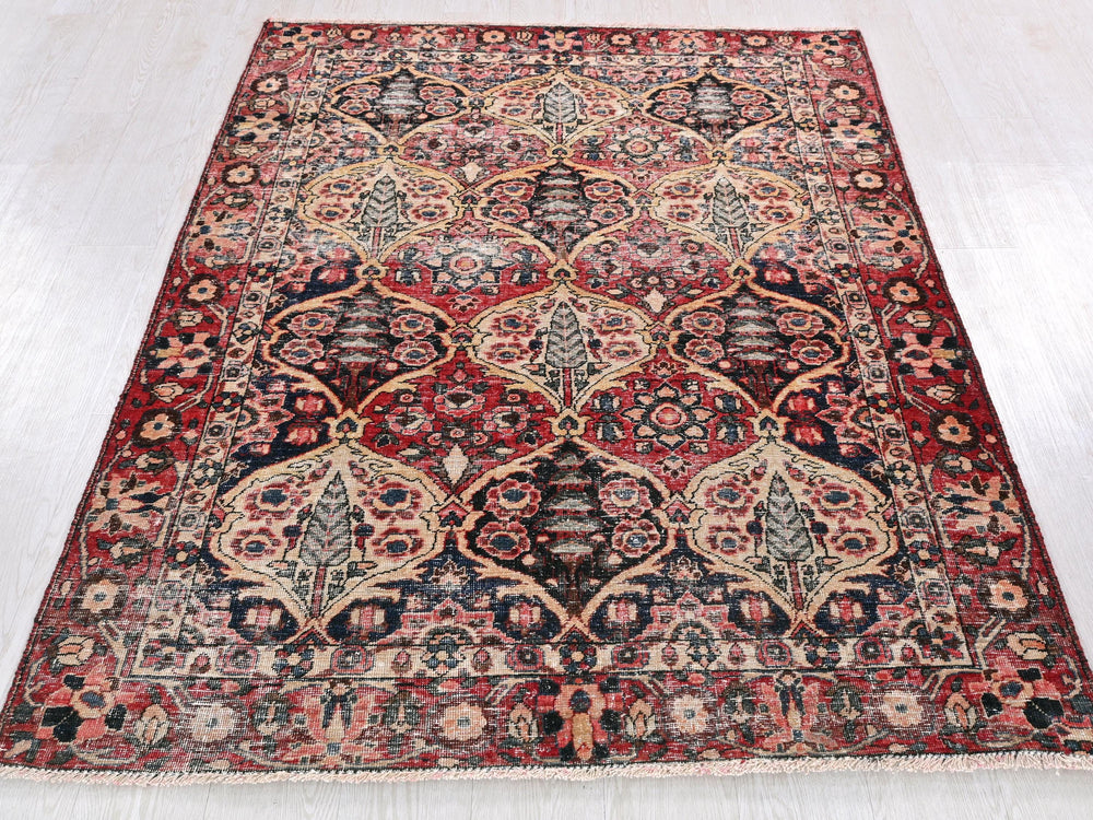 a red and black rug on a white floor
