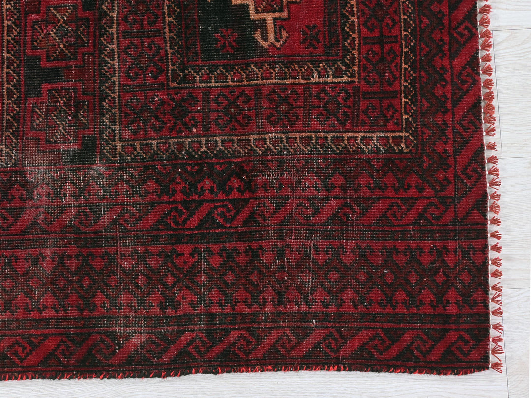 a close up of a red rug on a white surface