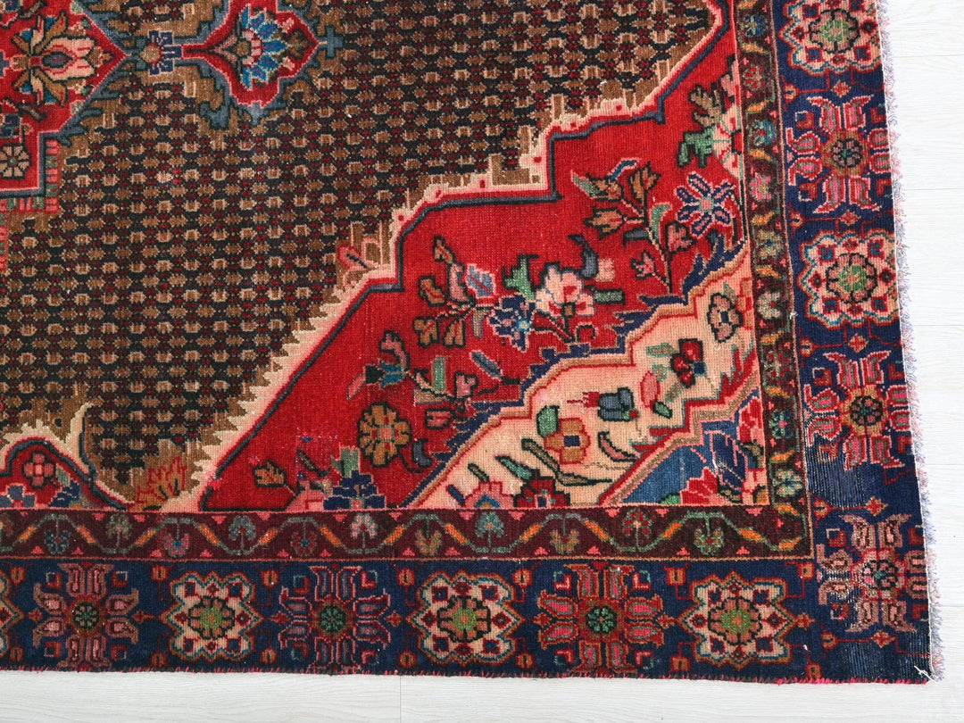 a red rug with many different designs on it
