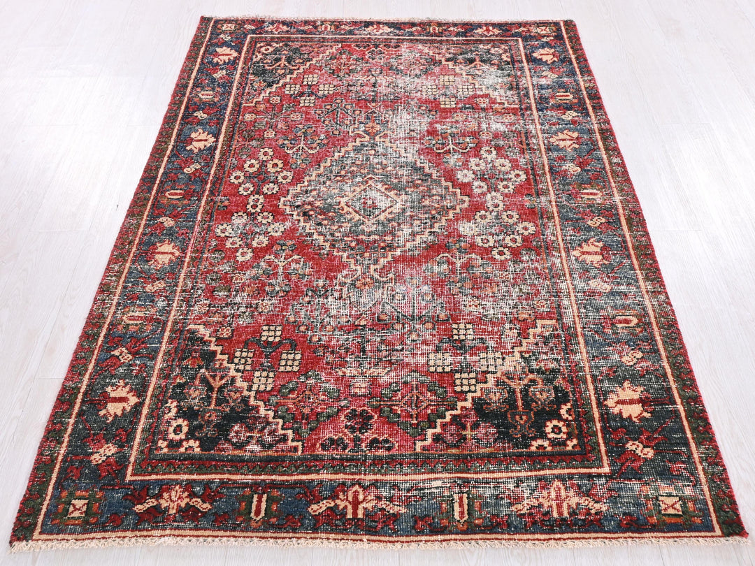 a red and blue rug on a white floor