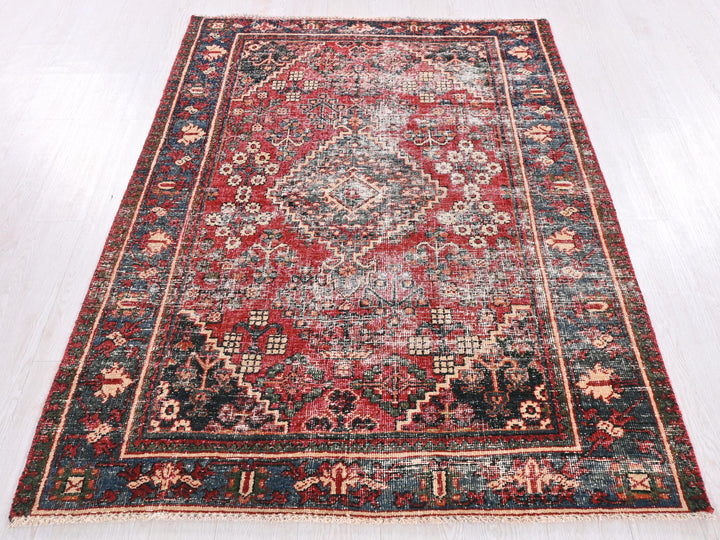 a red and blue rug on a white floor