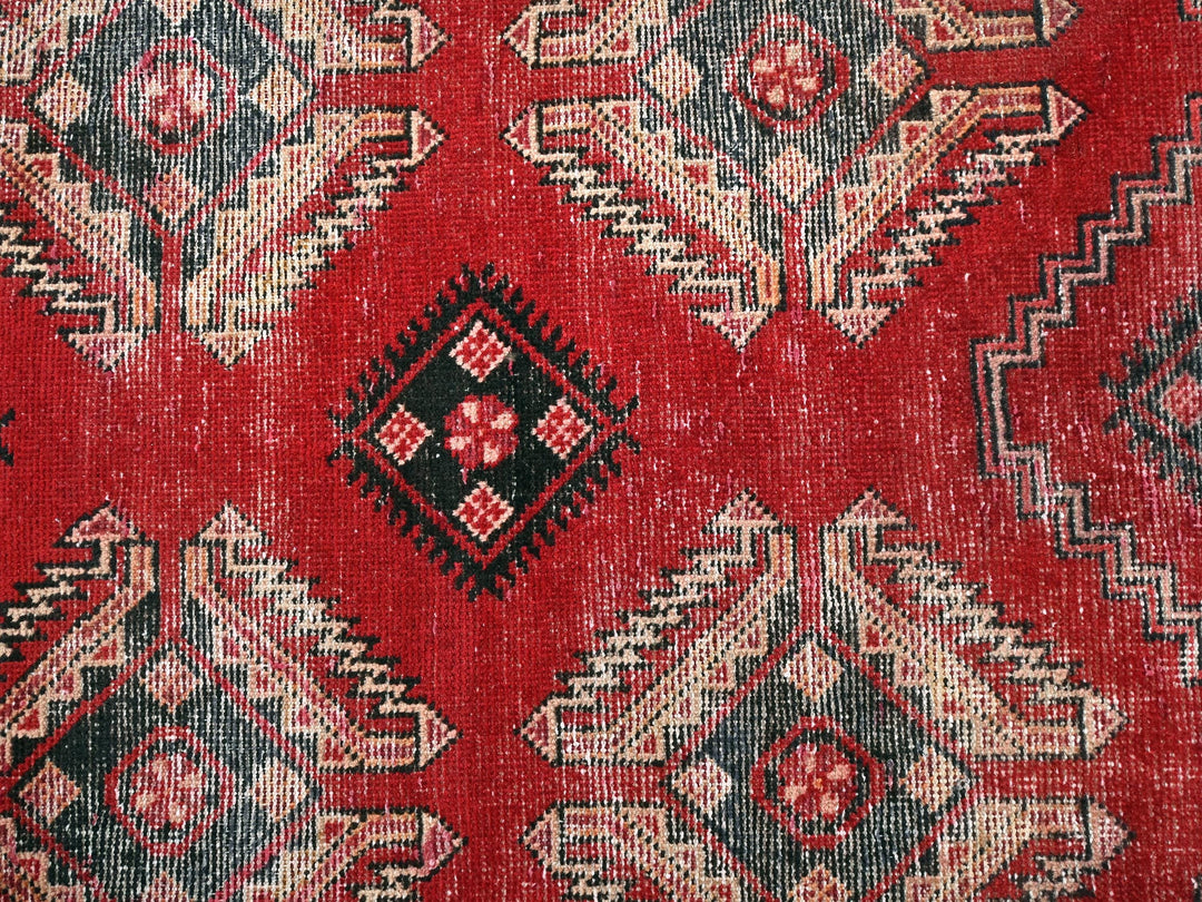 a close up of a red rug with a pattern