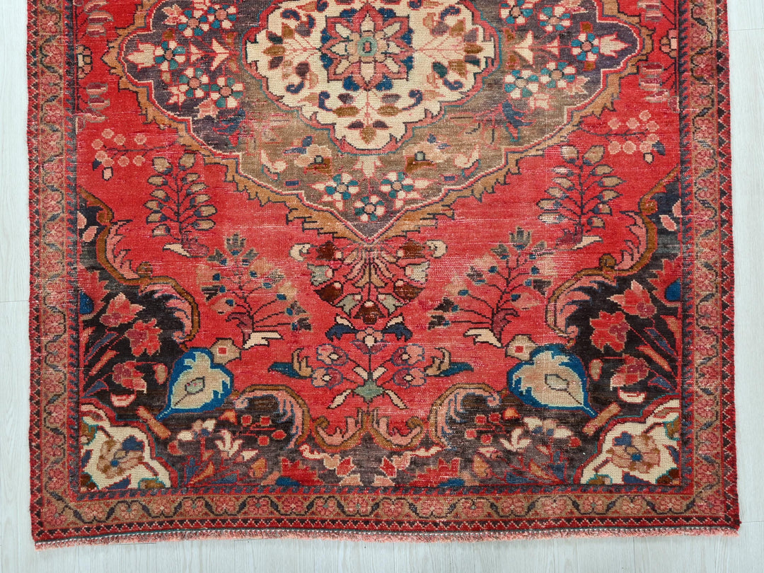 a red rug with a floral design on it