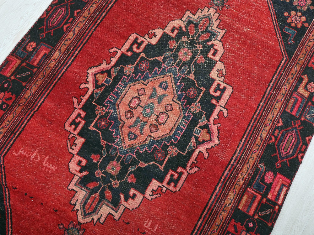 a close up of a red oriental rug