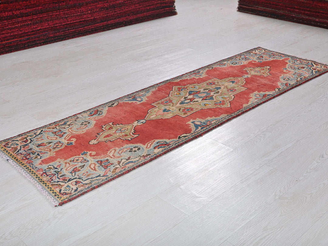 a red rug is laying on the floor