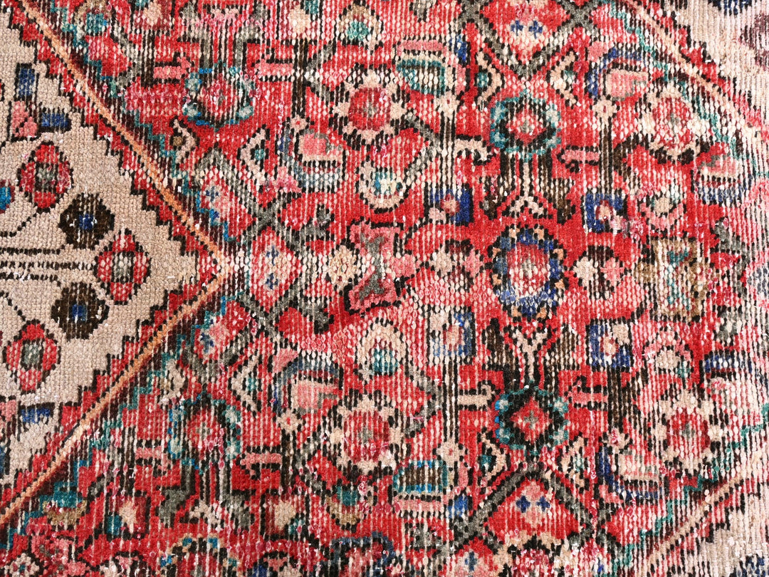 a close up of a red and blue oriental rug