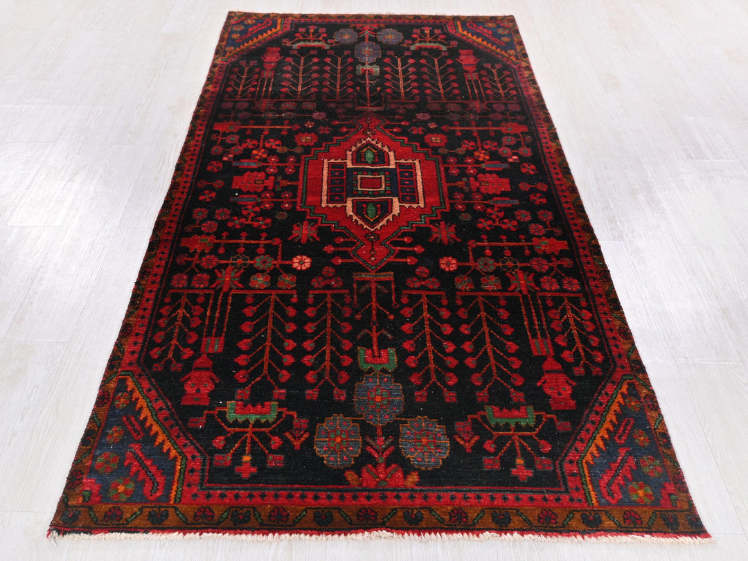 a red and black rug on a white floor