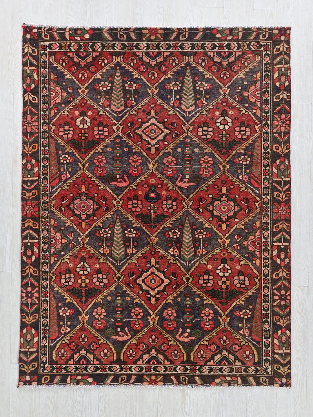 a red and blue rug with a pattern on it
