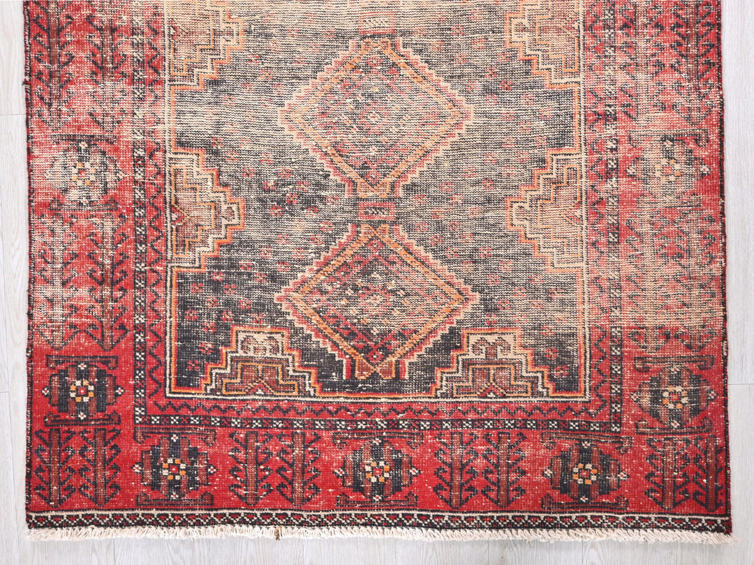 a red rug with a diamond pattern on it