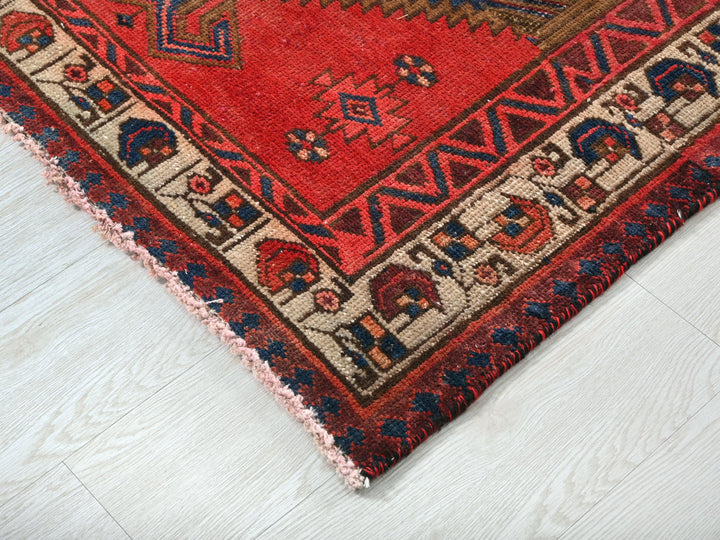 a red rug on a white wooden floor