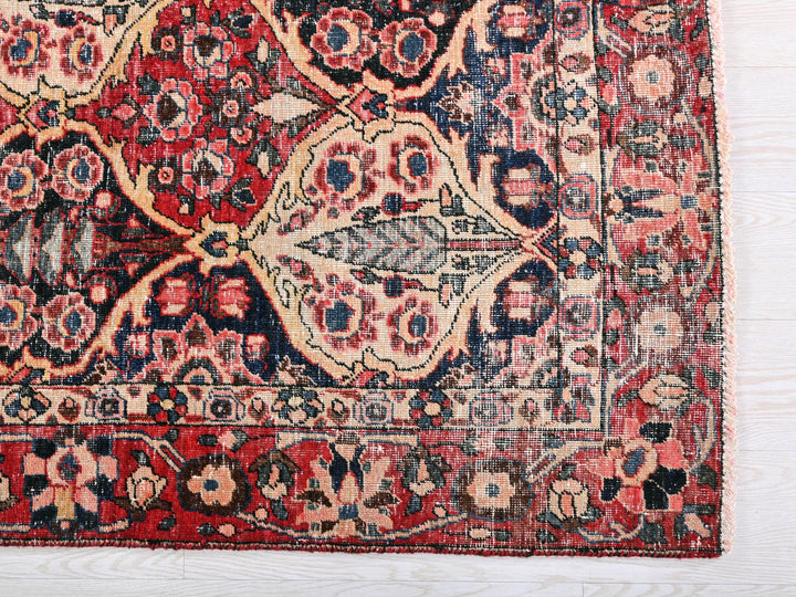 a red and blue rug on a white surface