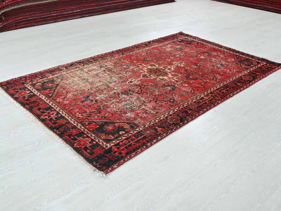 a red rug on the floor of a room
