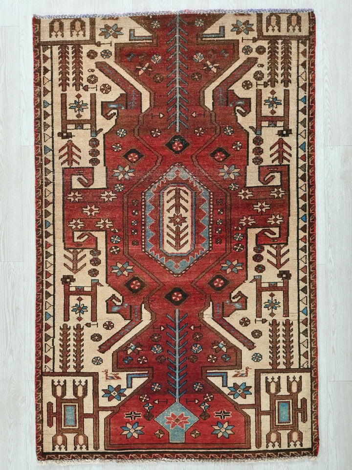 a red rug with a design on it