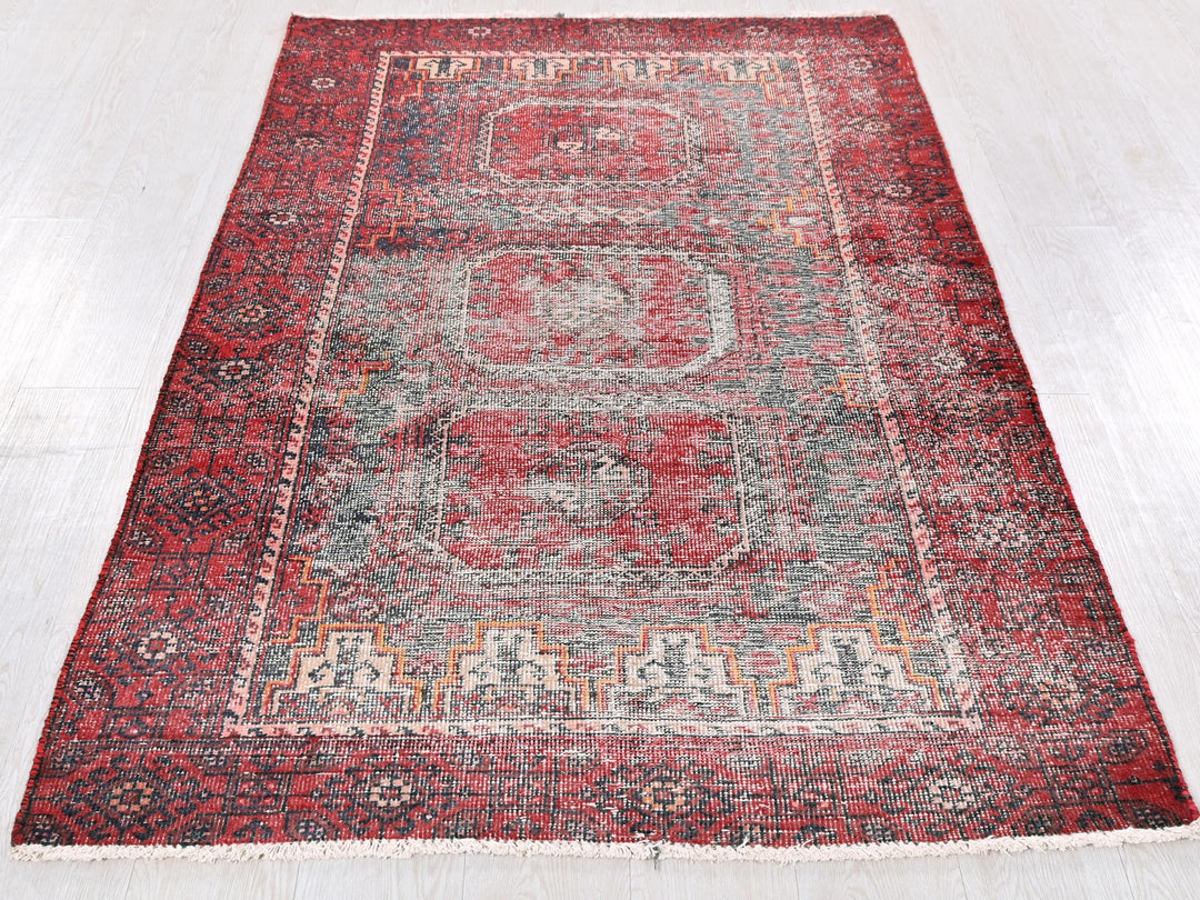 a red rug on a white floor in a room