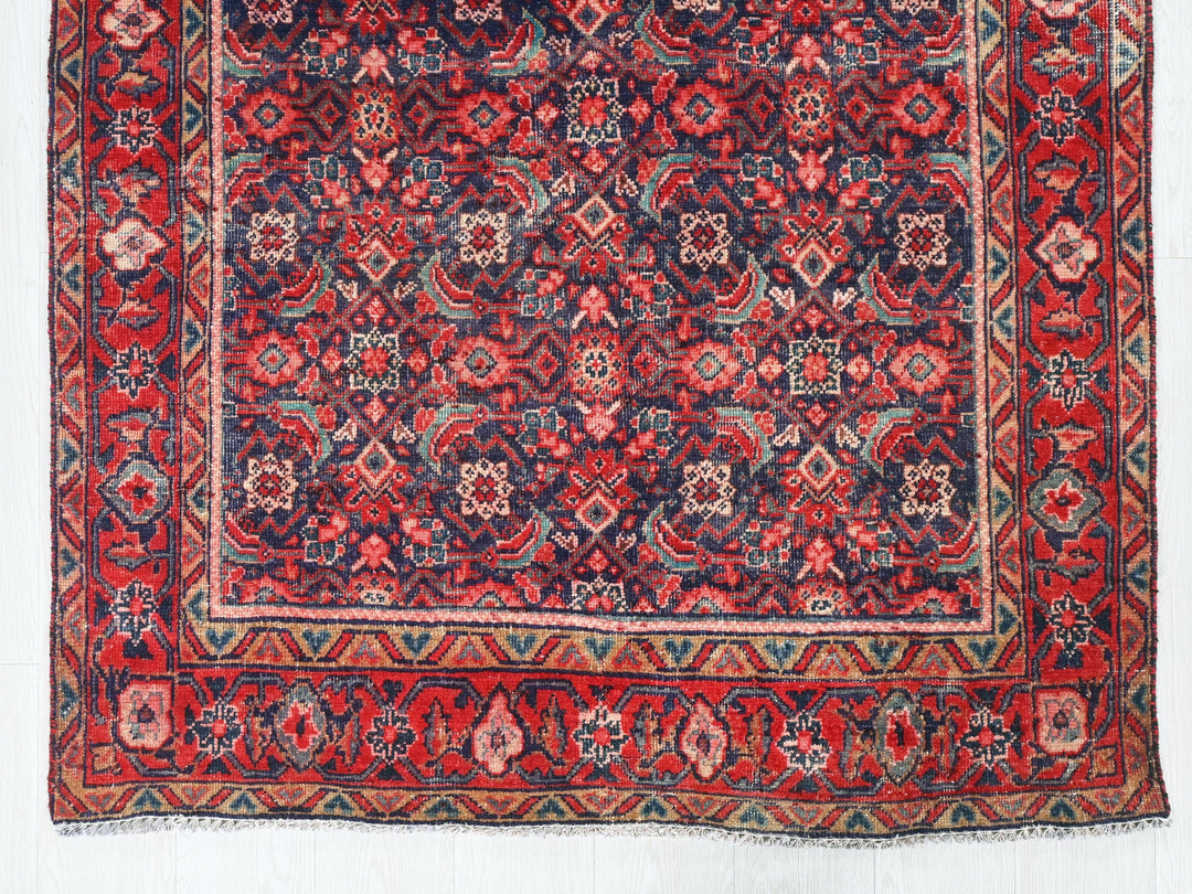 a red and blue rug with a design on it