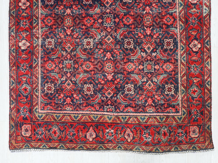 a red and blue rug with a design on it