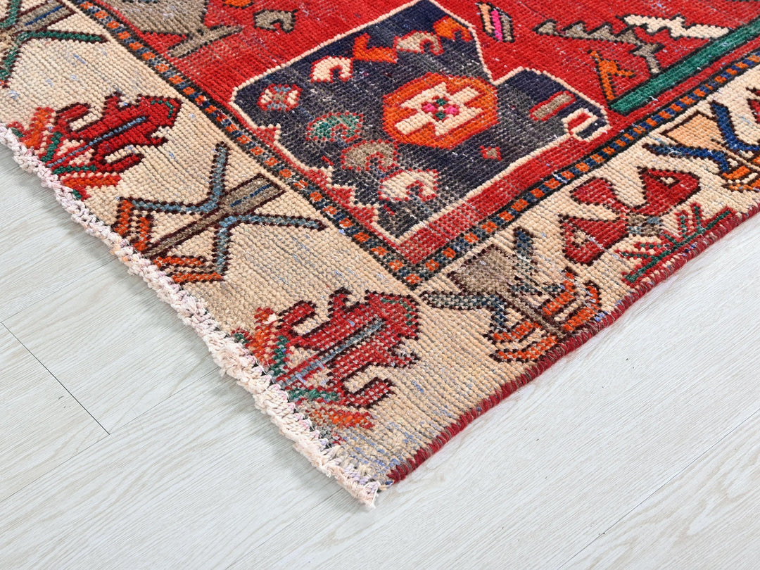 a red rug on a white wooden floor