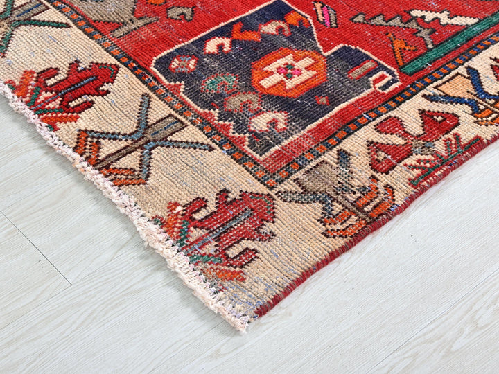 a red rug on a white wooden floor