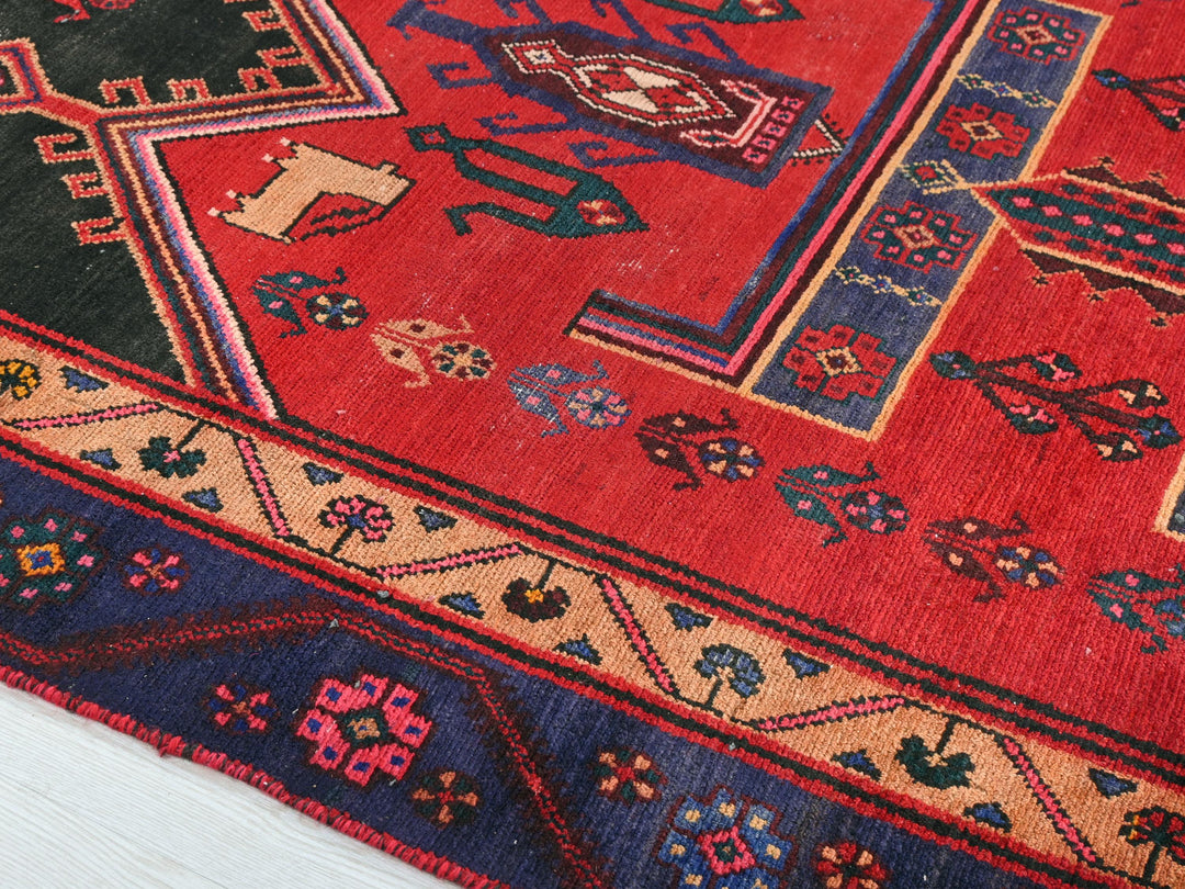 a red rug with a colorful design on it