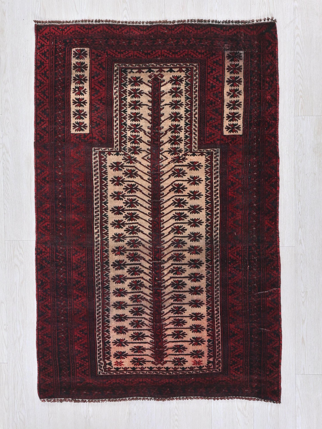 a red and white rug with a design on it