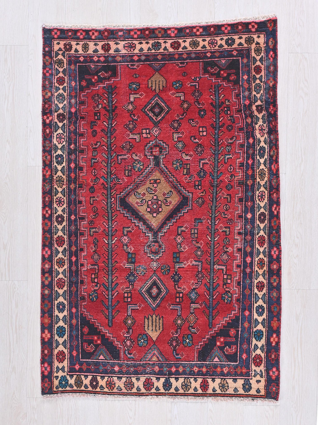 a red rug on a white wooden floor