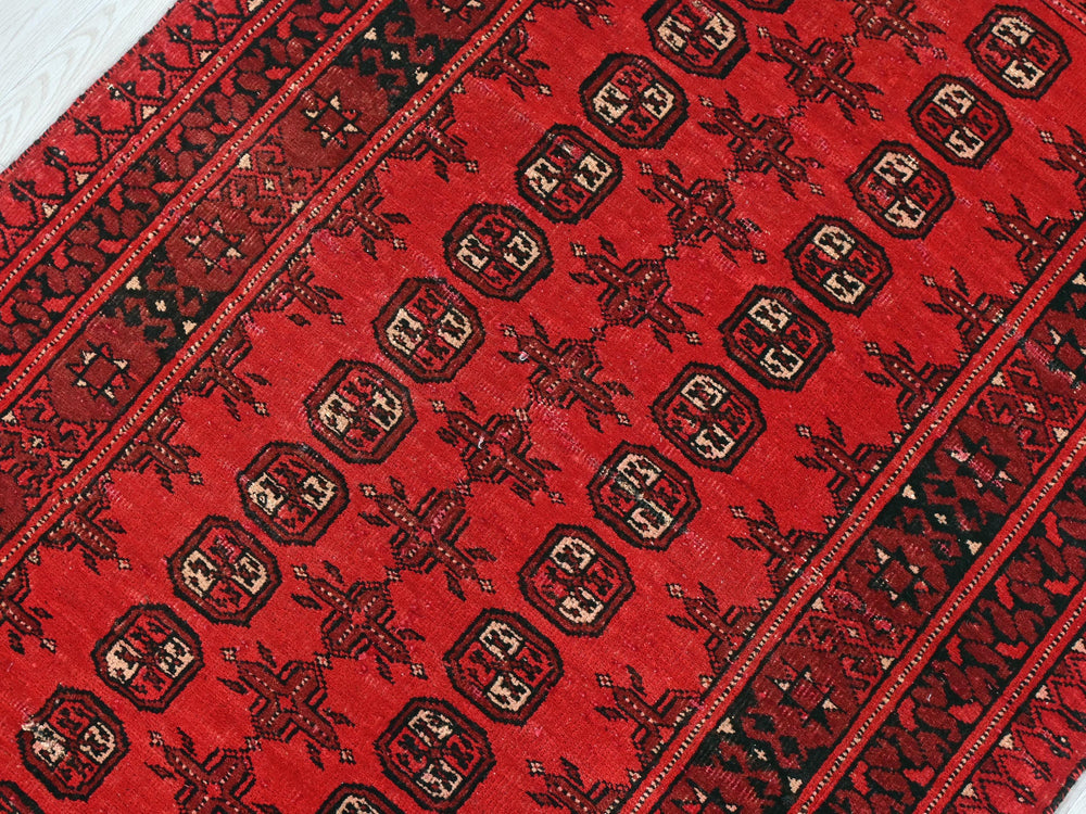 a close up of a red and black oriental rug