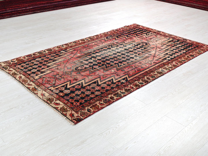 a red and black rug on a white floor