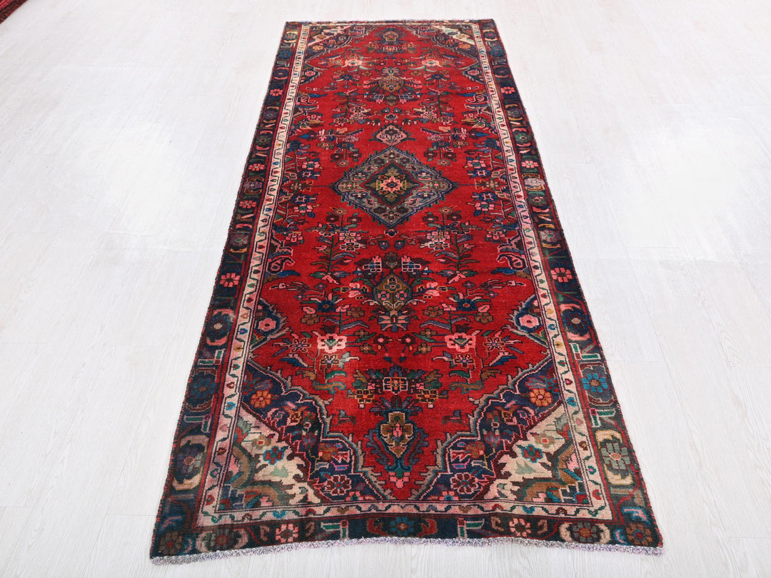 a red rug on a white floor in a room