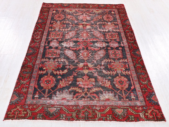 a red and black rug on a white floor