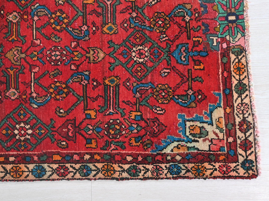 a red rug with many different designs on it