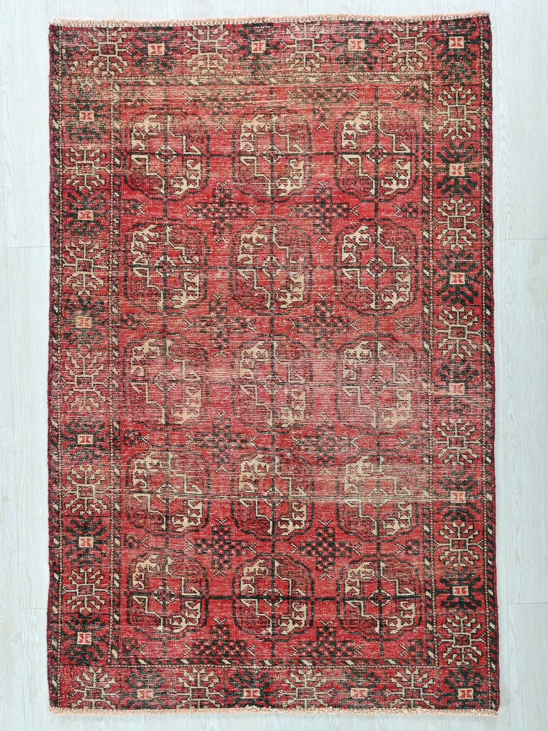 a red rug with a pattern on the middle of it